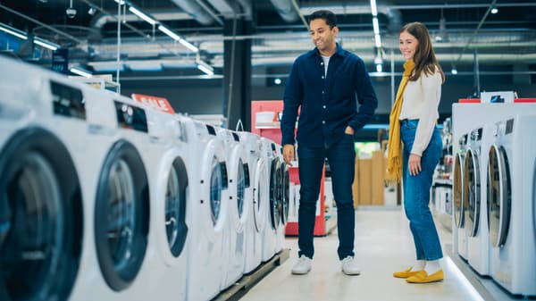 iStock Credit:gorodenkoff A woman and a man reviewing front load washers
